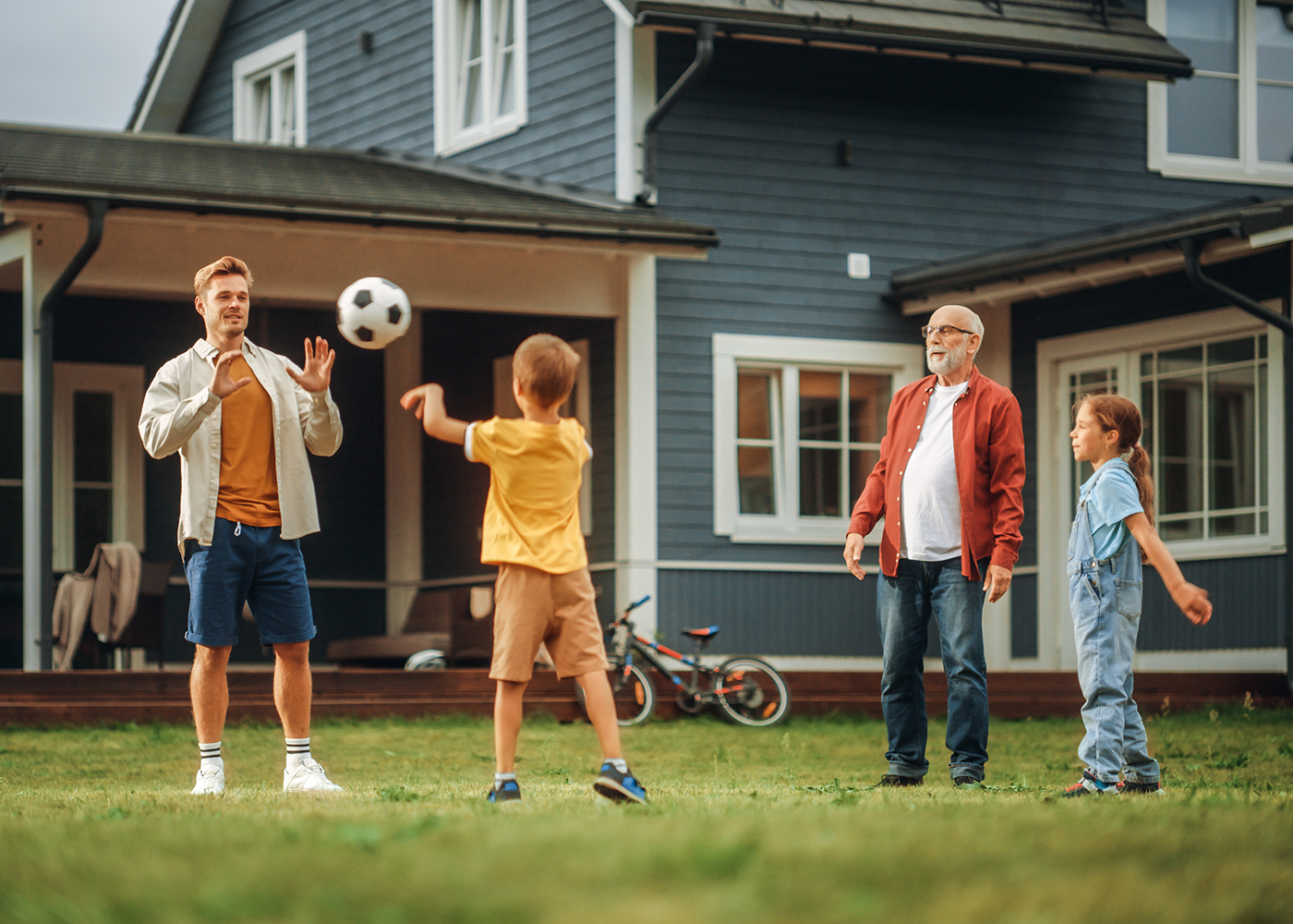 Family playing in front yard