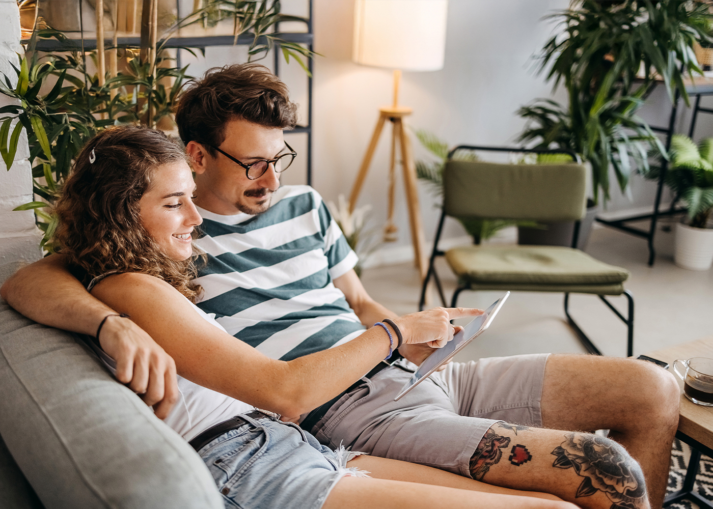 Couple on the couch looking at a tablet