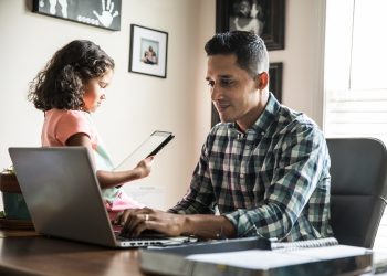 father and daughter using technology