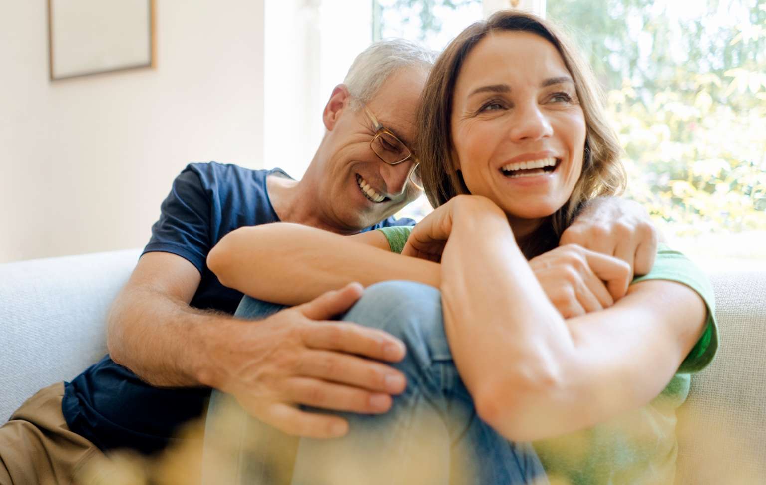 Couple laughing on couch 3