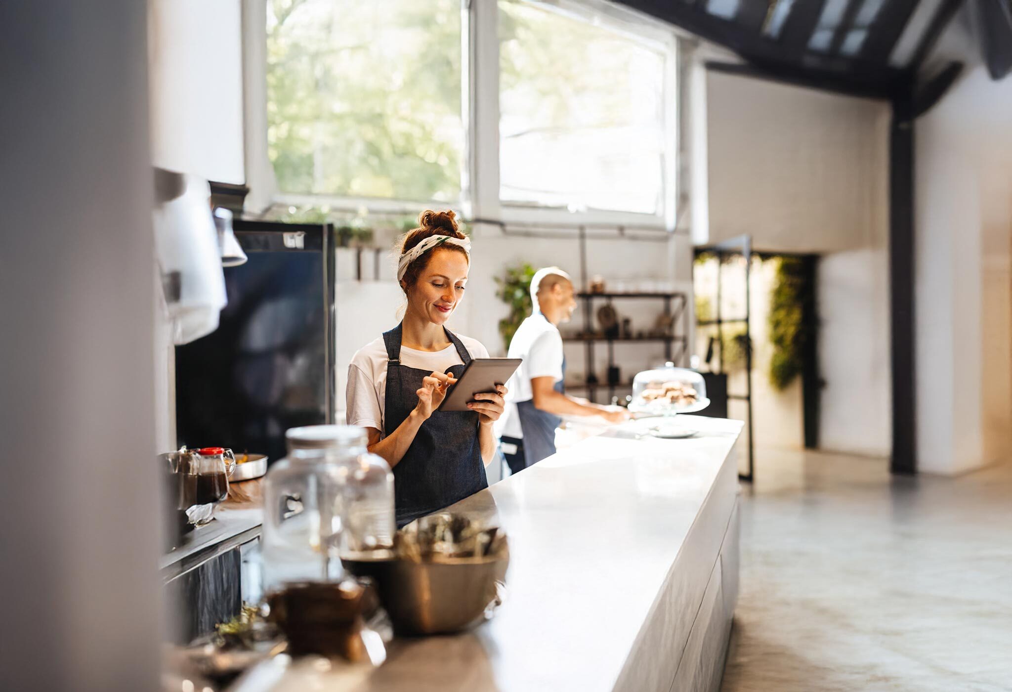 Woman using tablet in commercial kitchen