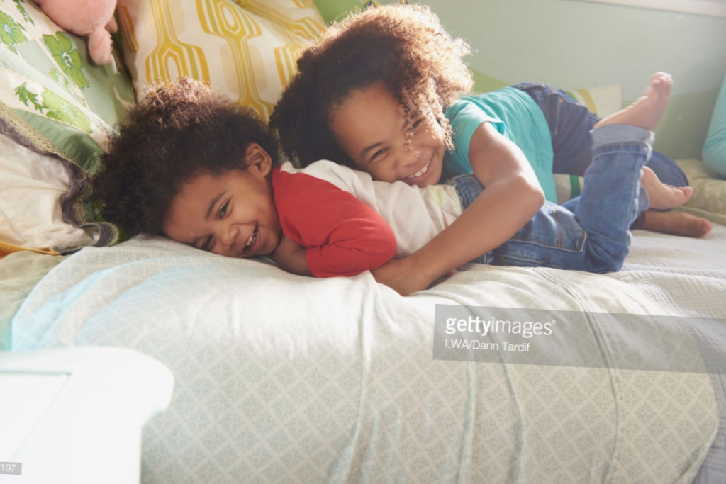 Two Kids Playing on Bed