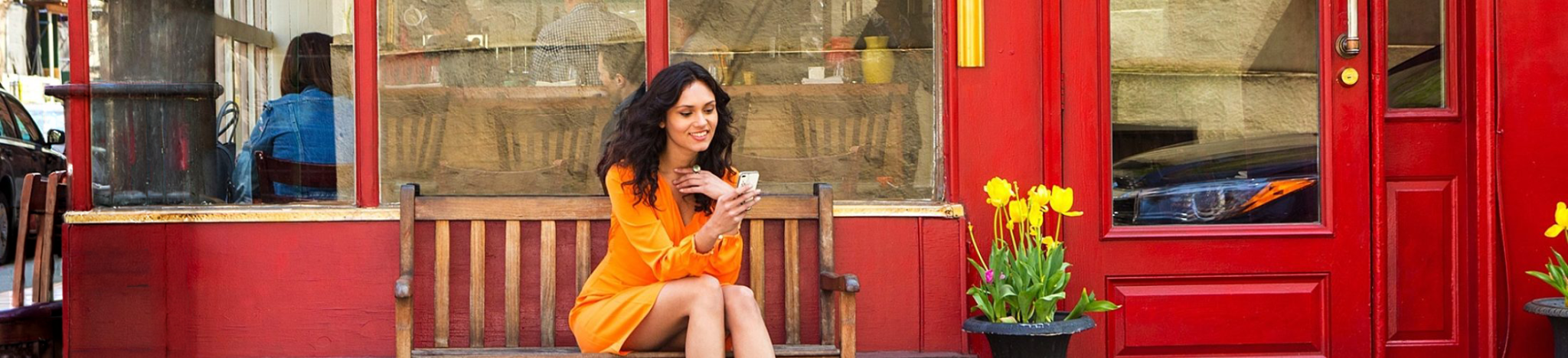 Women orange dress sitting credit companion phone